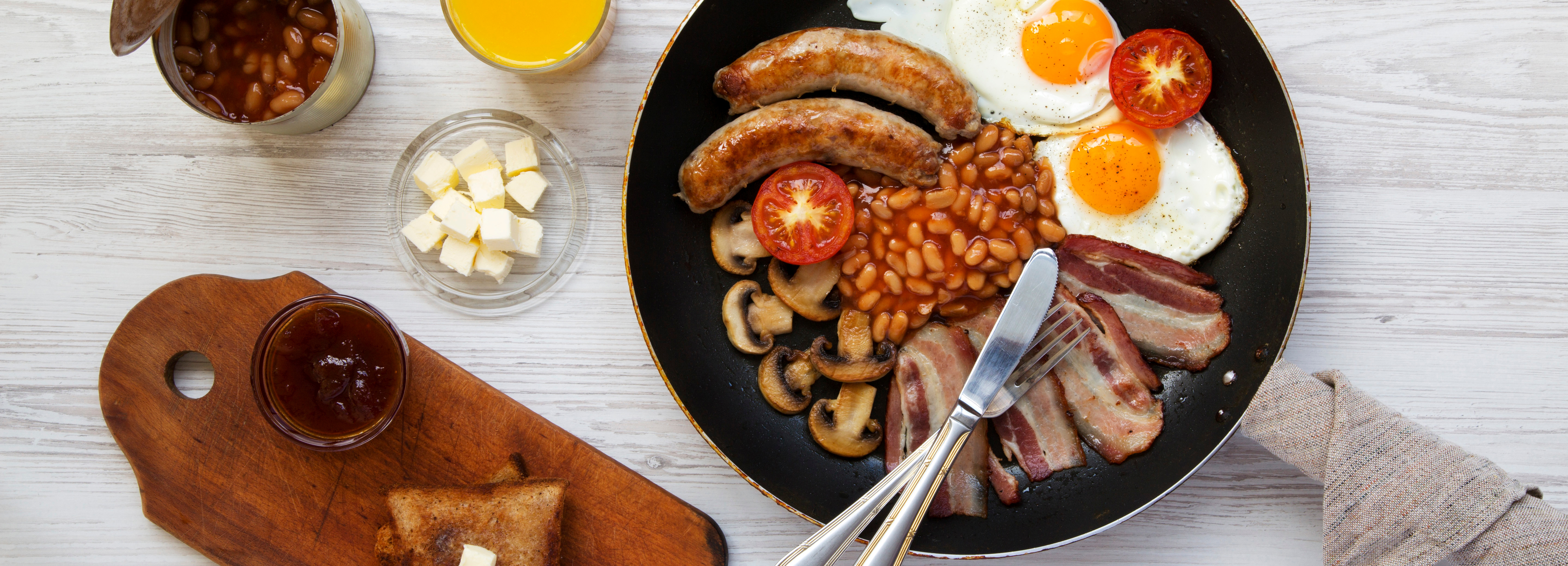 Full English breakfast with eggs, sausages, and beans served at Sandringham Hotel.